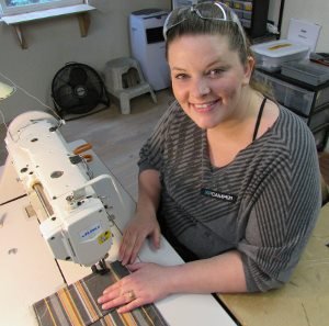 Kayla Sylva, 28, is training to stitch cushions for high-quality campers built by hand at XP Camper, a Grass Valley manufacturer that exports all over the world. The “Leap of Faith” matching fund drive, sponsored by PEACE Lutheran Church, supports the local services that helped Sylva move from chaos to stability.