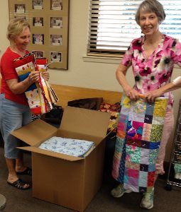 Peacemakers members Ann Campbell, left, and Marilyn Engleking pack quilts made by the quilting group based at PEACE Lutheran Church, in Grass Valley, for shipment to victims of the Erskine Fire near the town of Lake Isabella, Calif.