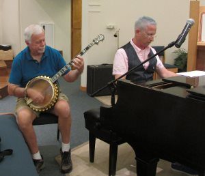 Bob Duegan, on the banjo, and Thomas Greathouse, on piano, joined nearly 30 other musicians in PEACE's Texas Hurricane Fundraising Concert on Sept. 3.
